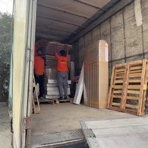Warehouse relocation crew moving palletised stock
